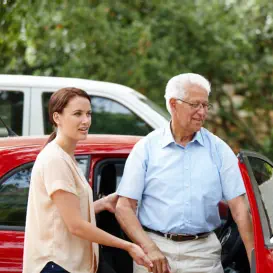 senior assisted by woman
