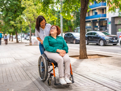 woman assisting woman in wheelchair