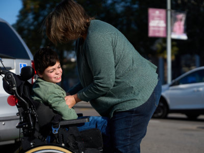 woman assisting child with disability