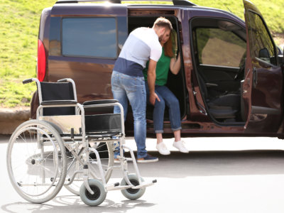 man assisting woman from vehicle