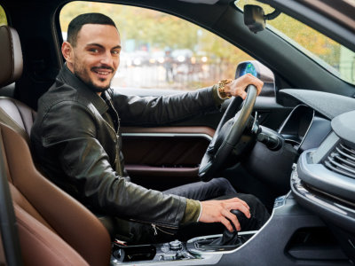 man inside car smiling