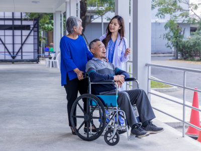 senior being released from hospital with assistant