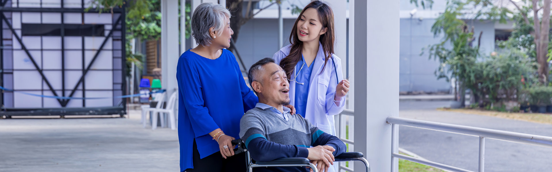 senior in wheelchair with doctor smiling