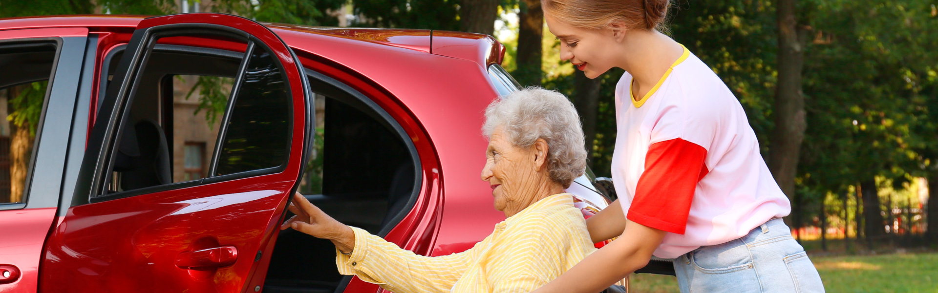 senior in wheelchair assisted to vehicle