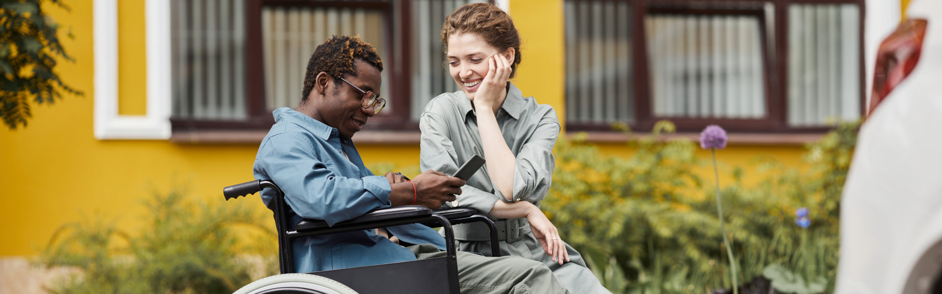 woman accompanying man in wheelchair