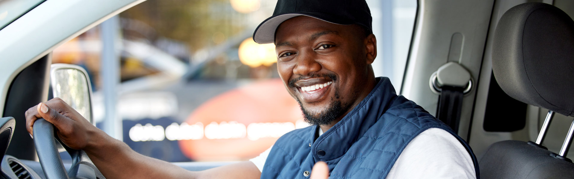 man inside vehicle smiling