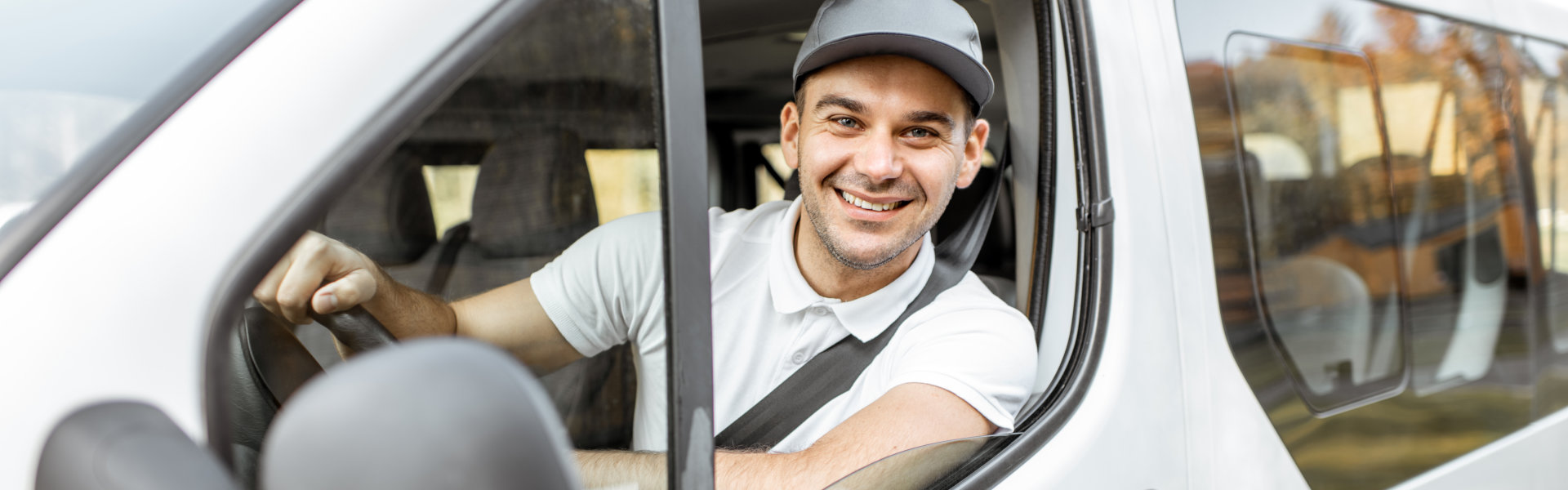 young man inside van smiling